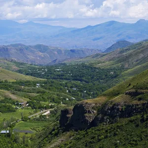 Extensive valley surrounded by green mountains Extensive valley surrounded by green mountains