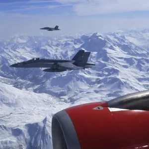Two FA-18 Fighters Accompaning a Civil Airplaine over the Swiss Alps Two FA-18 Fighters Accompaning a Civil Airplaine over the Swiss Alps