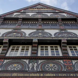 Facade of an artfully decorated historic half-timbered house with rich ornaments and paintings