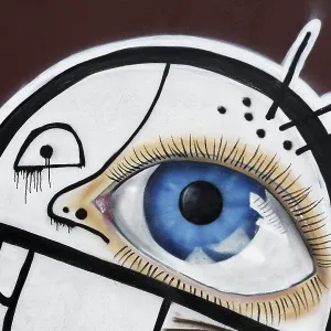 Face with one large eye, graffiti