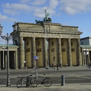 Famous gate in Berlin, Brandenburg Gate with a few bicycles in the foreground and blue sky
