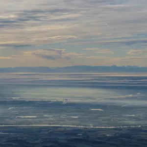 A far-reaching landscape shows sky and clouds over mountains A far-reaching landscape shows sky and clouds over mountains