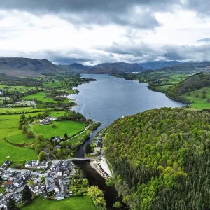 Farms and mountains over Ullswater Lake from drone