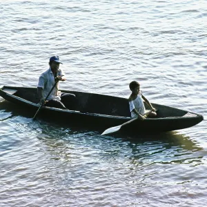 Father and child in a paddle boat on the Amazon near Iquitos Father and child in a paddle boat on the Amazon near Iquitos