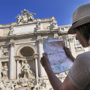 Female tourist with a map, in front of Trevi Fountain Female tourist with a map, in front of Trevi Fountain