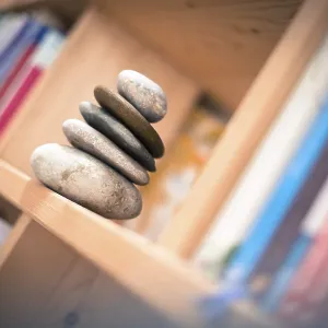 Feng Shui: Stone cairn at home in a book shelf