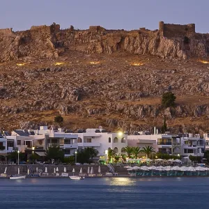 Feraklos fortress, Old castle at dusk with illuminated town and calm sea below Feraklos fortress, Old castle at dusk with illuminated town and calm sea below