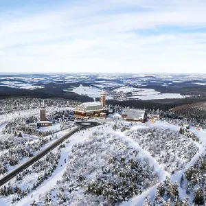 Fichtelberg highest mountain in the Ore Mountains in winter aerial view panorama in Oberwiesenthal