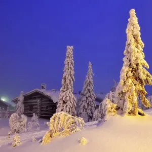 Finnish log cabin in the snow-covered landscape