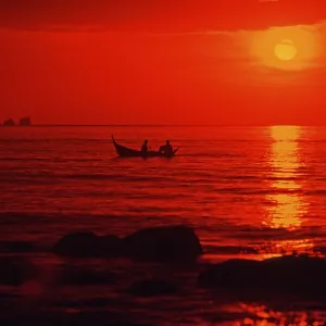 Fishing boat at sunset, silhouettes Fishing boat at sunset, silhouettes