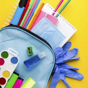 Flat lay school essentials with gloves backpack