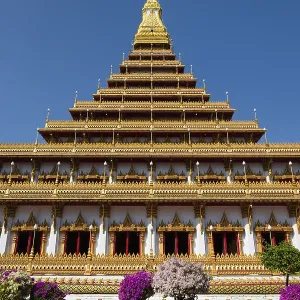 Flowering bushes in front of nine-story stupa Phra Mahathat Kaen Kakhon