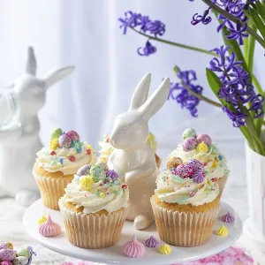 Food, Sweet and tasty Easter cupcakes decorated with colorful sprinkles end candy eggs Food, Sweet and tasty Easter cupcakes decorated with colorful sprinkles end candy eggs
