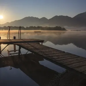 Footbridge on lake in front of mountains Footbridge on lake in front of mountains