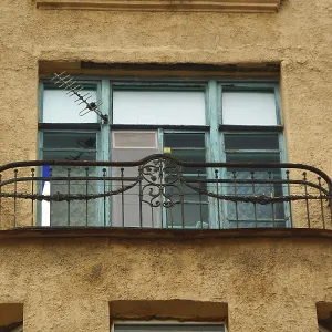 Fragment of the facade with a balcony of an Art Nouveau-style residential building on one of the streets in the city