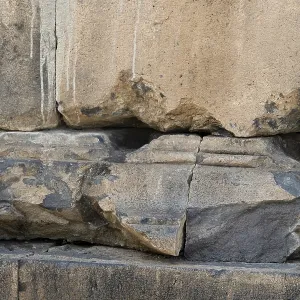 Fragment of a stone wall of an ancient temple made of tufa Fragment of a stone wall of an ancient temple made of tufa