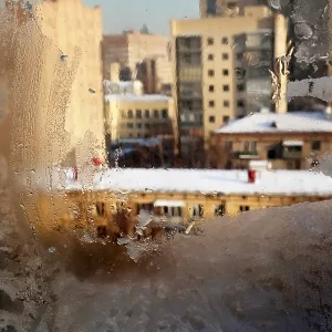 Frozen window on a background the covered sun city Frozen window on a background the covered sun city