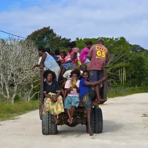 Fully loaded tractor transporting field workers