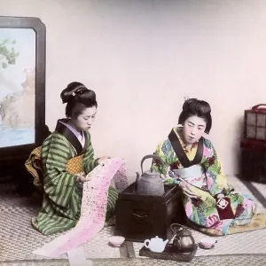 Two geishas reading and drinking tea, Japan, Asia