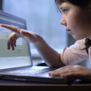 Girl, 10 years, with laptop, on Facebook web page