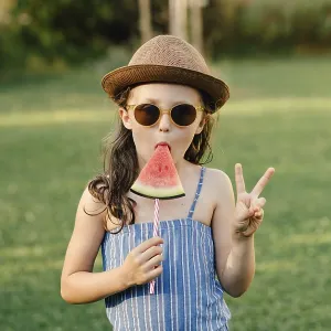 Girl eats watermelon on a stick Girl eats watermelon on a stick