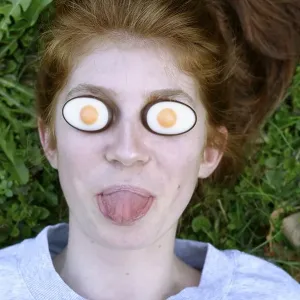 Girl, funny portrait, Easter eggs on the eyes Girl, funny portrait, Easter eggs on the eyes