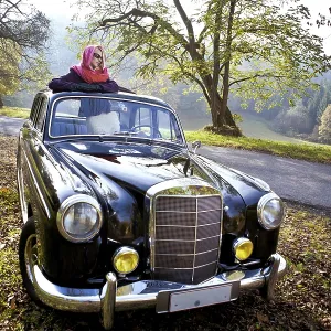 Girl in front of Post-War classic car