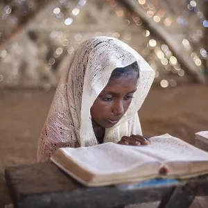 Girl reading in a madrasah, Koran school