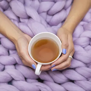 A girl wrapped in a large pink merino wool blanket A girl wrapped in a large pink merino wool blanket