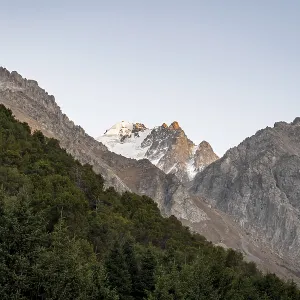 Glaciated mountain peak at sunset Glaciated mountain peak at sunset