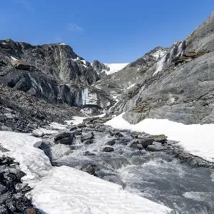 Glacier ice and glacier stream with waterfall