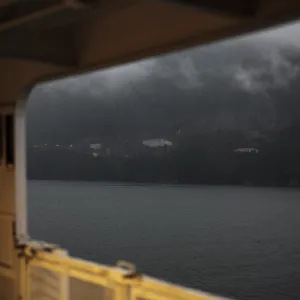 Gloomy mountain landscape viewed from inside a ship amid heavy clouds in Horseshoe Bay Gloomy mountain landscape viewed from inside a ship amid heavy clouds in Horseshoe Bay