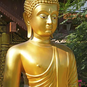 Golden Buddha figure in front of Wat Phra Bat Ming Muang Golden Buddha figure in front of Wat Phra Bat Ming Muang