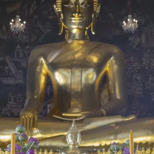 Golden Buddha statue, Phra Buddha Trilokachet surrounded by crystal chandeliers and exquisite wall paintings Golden Buddha statue, Phra Buddha Trilokachet surrounded by crystal chandeliers and exquisite wall paintings