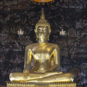 Golden Buddha statue, Phra Buddha Trilokachet surrounded by crystal chandeliers and exquisite wall paintings Golden Buddha statue, Phra Buddha Trilokachet surrounded by crystal chandeliers and exquisite wall paintings