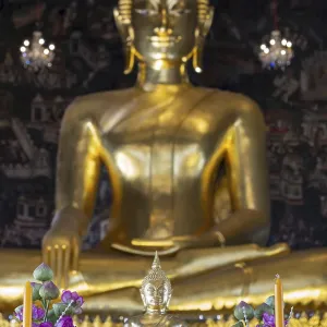 Golden Buddha statue, Phra Buddha Trilokachet surrounded by exquisite wall paintings Golden Buddha statue, Phra Buddha Trilokachet surrounded by exquisite wall paintings