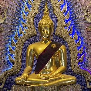 Golden Buddha statue with tunic
