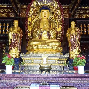 Golden Buddhist statues in a richly decorated worship room Golden Buddhist statues in a richly decorated worship room