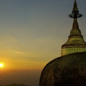 Golden Rock with stupa and sundown Kyaikhtiyo Pagoda Bago Burma