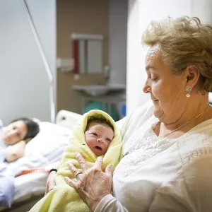 Grandmother with newborn in hospital