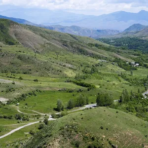 Green fields and rolling hills with roads leading through the area Green fields and rolling hills with roads leading through the area