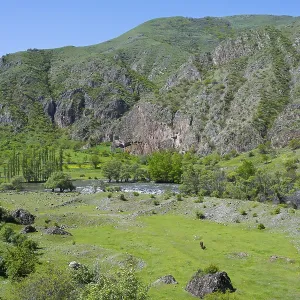 Green valley with agricultural environment and rolling hills