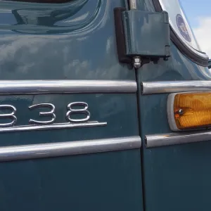 Green vintage car with tail light and the number 338 on the bodywork
