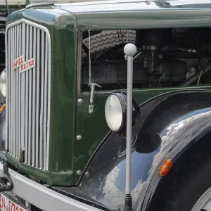 Green vintage lorry with classic radiator grille and headlights