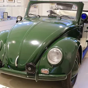 A green Volkswagen Beetle Cabriolet in shiny condition stands in the museum A green Volkswagen Beetle Cabriolet in shiny condition stands in the museum