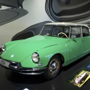 Green and white vintage car from 1956 in the museum