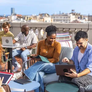 Group of diverse business people meeting and working together casually on a rooftop terrace