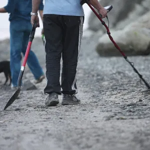 Group of treasure hunters with a dog at work Group of treasure hunters with a dog at work