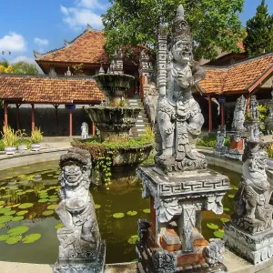 Guardian figures in front of an old well in Brahma Vihara Arama Buddha Banjar Buddhist monastery Guardian figures in front of an old well in Brahma Vihara Arama Buddha Banjar Buddhist monastery