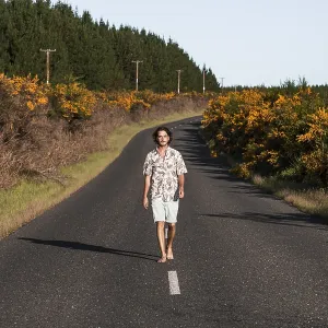 Guy walking on a road, Rotorua